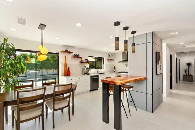 a kitchen with stainless steel appliances a sink a stove a refrigerator cabinets and a counter space