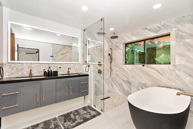 a view of a patio with table and chairs potted plants and large tree