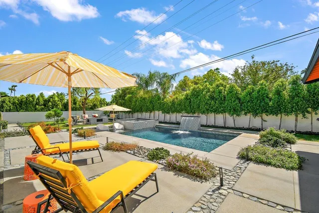 a view of a patio with swimming pool table and chairs