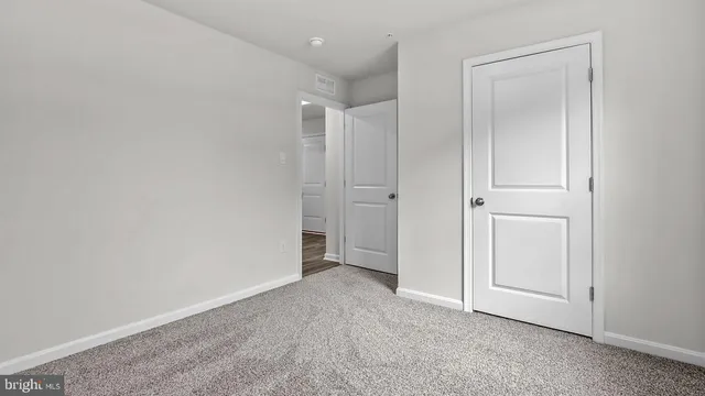 an empty room with closet area