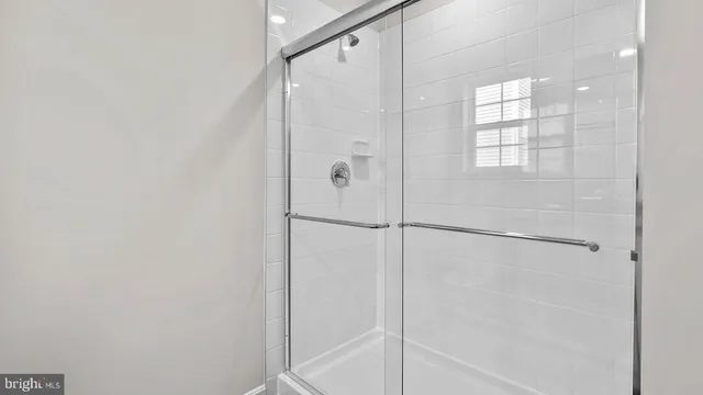 a bathroom with a glass shower door