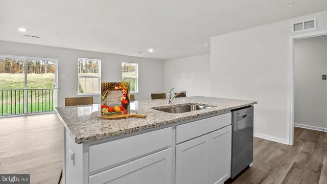 a hallway with sink and mirror
