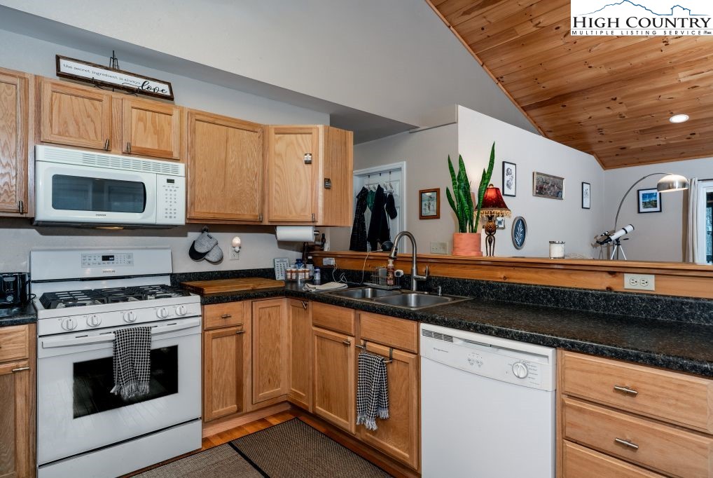 3564 Hickory Nut Gap Road Newland, NC 28657 - Photo 11 of 35 a kitchen with stainless steel appliances a stove sink microwave and cabinets