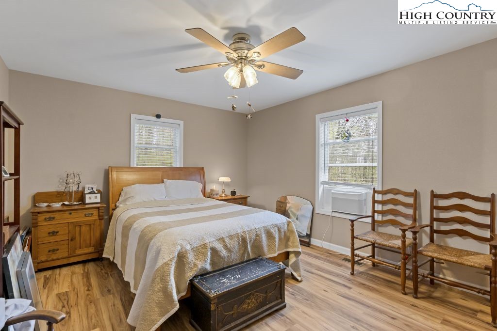 3564 Hickory Nut Gap Road Newland, NC 28657 - Photo 11 of 30 a bedroom with a bed and a chandelier