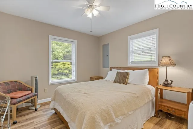 a bedroom with a bed and a chandelier