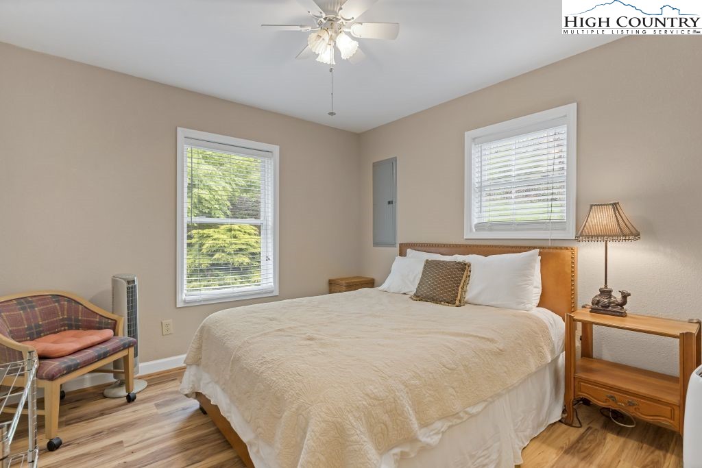 3564 Hickory Nut Gap Road Newland, NC 28657 - Photo 13 of 30 a bedroom with a bed and a chandelier