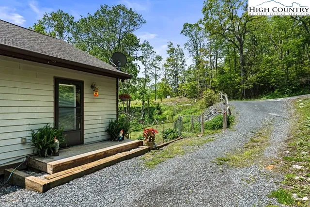 a view of a pathway of the house with flower pots