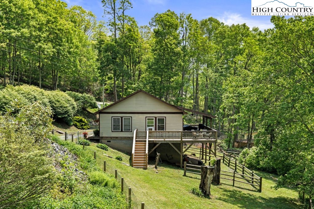 3564 Hickory Nut Gap Road Newland, NC 28657 - Photo 2 of 35 a view of a chair and table in the backyard of the house