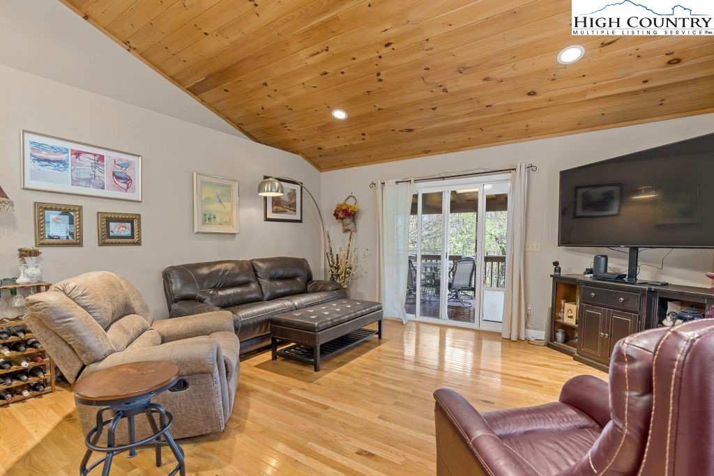 3564 Hickory Nut Gap Road Newland, NC 28657 - Photo 2 of 30 a living room with furniture a flat screen tv and wooden floor