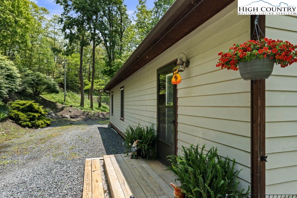 3564 Hickory Nut Gap Road Newland, NC 28657 - Photo 21 of 30 a view of a pathway of the house with flower pots