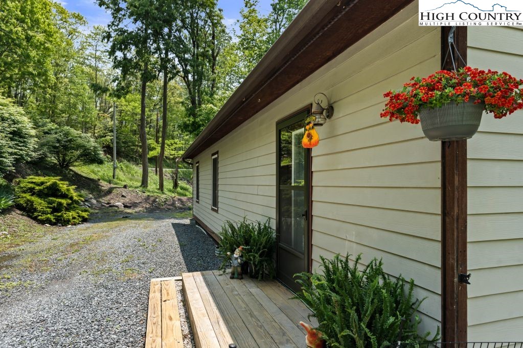 3564 Hickory Nut Gap Road Newland, NC 28657 - Photo 26 of 35 a view of a pathway of the house with flower pots