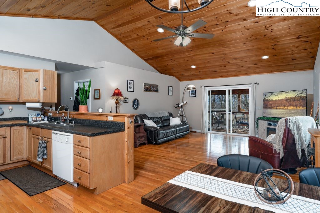 3564 Hickory Nut Gap Road Newland, NC 28657 - Photo 9 of 35 a kitchen with stainless steel appliances granite countertop a sink dishwasher a stove with wooden cabinets and floor