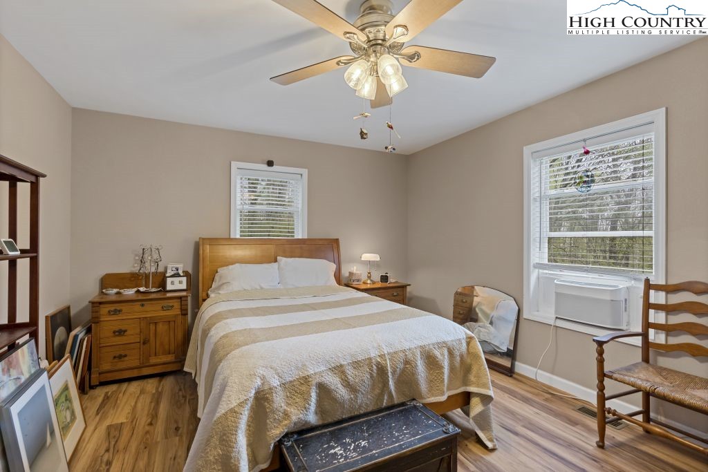 3564 Hickory Nut Gap Road Newland, NC 28657 - Photo 10 of 30 a bedroom with a bed and a chandelier