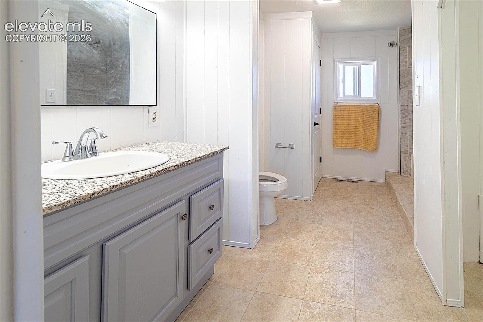 3425 Wiesner Road Calhan, CO 80808 - Photo 12 of 25 Bathroom featuring vanity, toilet, and tile patterned flooring