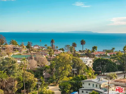 an aerial view of a house with a lake view
