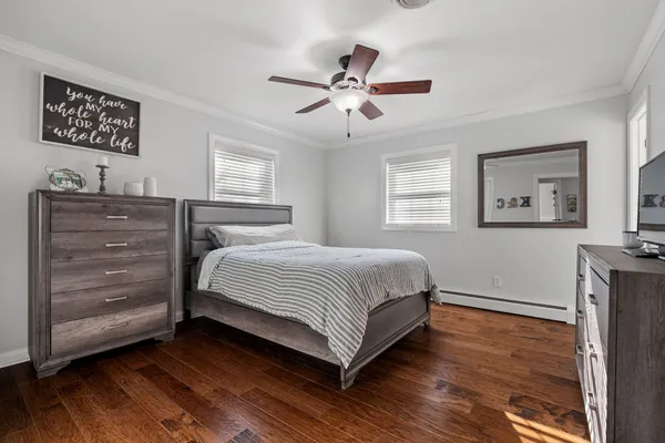 a bedroom with a large bed and a chandelier
