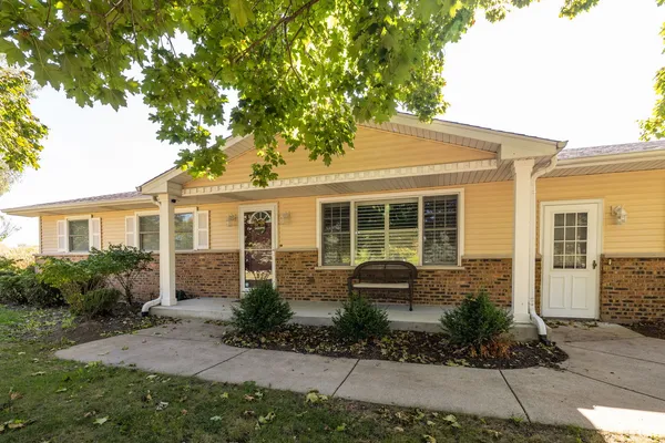 a front view of a house with garden and porch