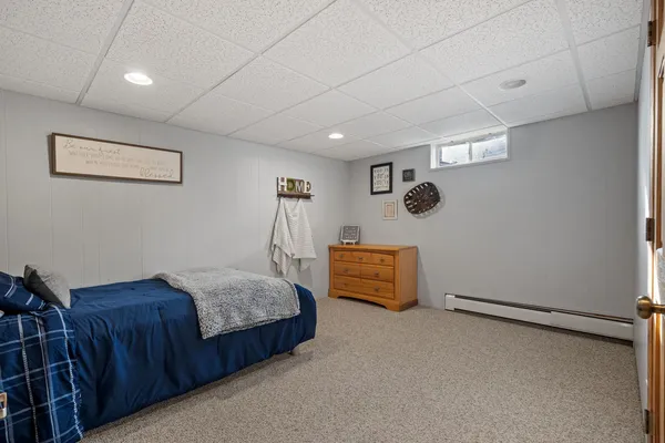 a bedroom with furniture and a window