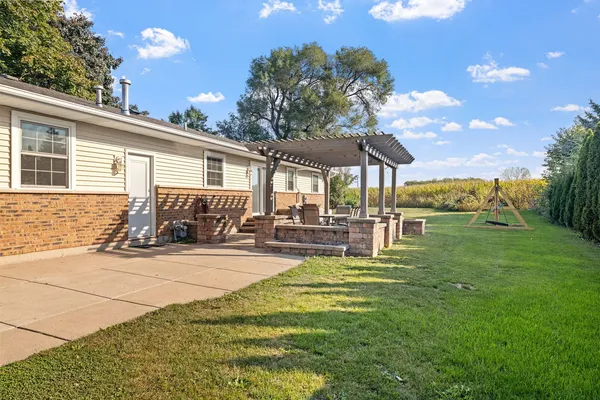 a view of a house with backyard porch and sitting area