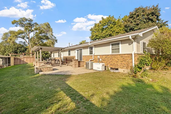 a view of a house with backyard and sitting area