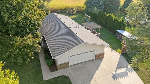 an aerial view of a house with a yard and balcony