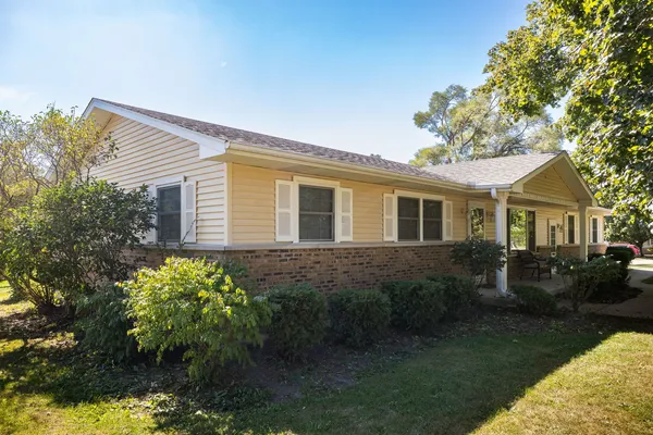 a view of a house with backyard and sitting area