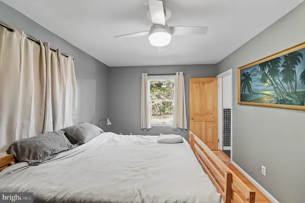 a bedroom with a large bed and a large window