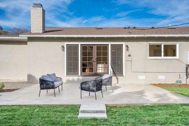 a view of house with patio outdoor seating and yard