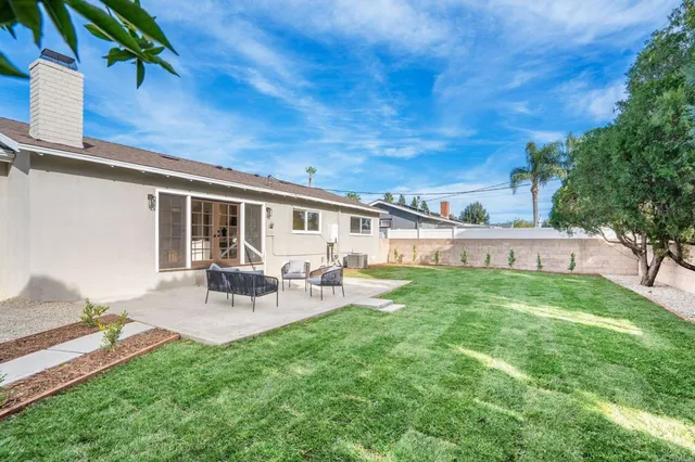 a view of backyard with a table and chairs