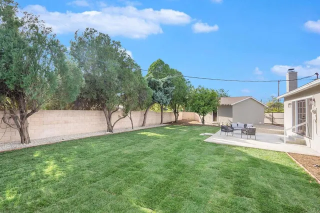 a view of a backyard with sitting area
