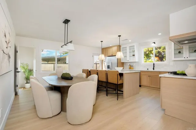 a living room with furniture a dining table and chairs
