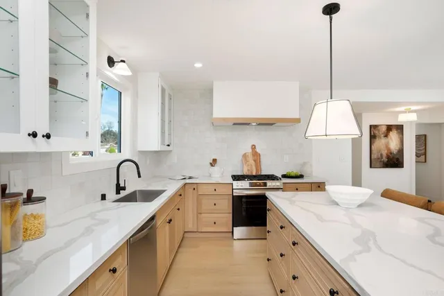 a kitchen with a sink stove and cabinets