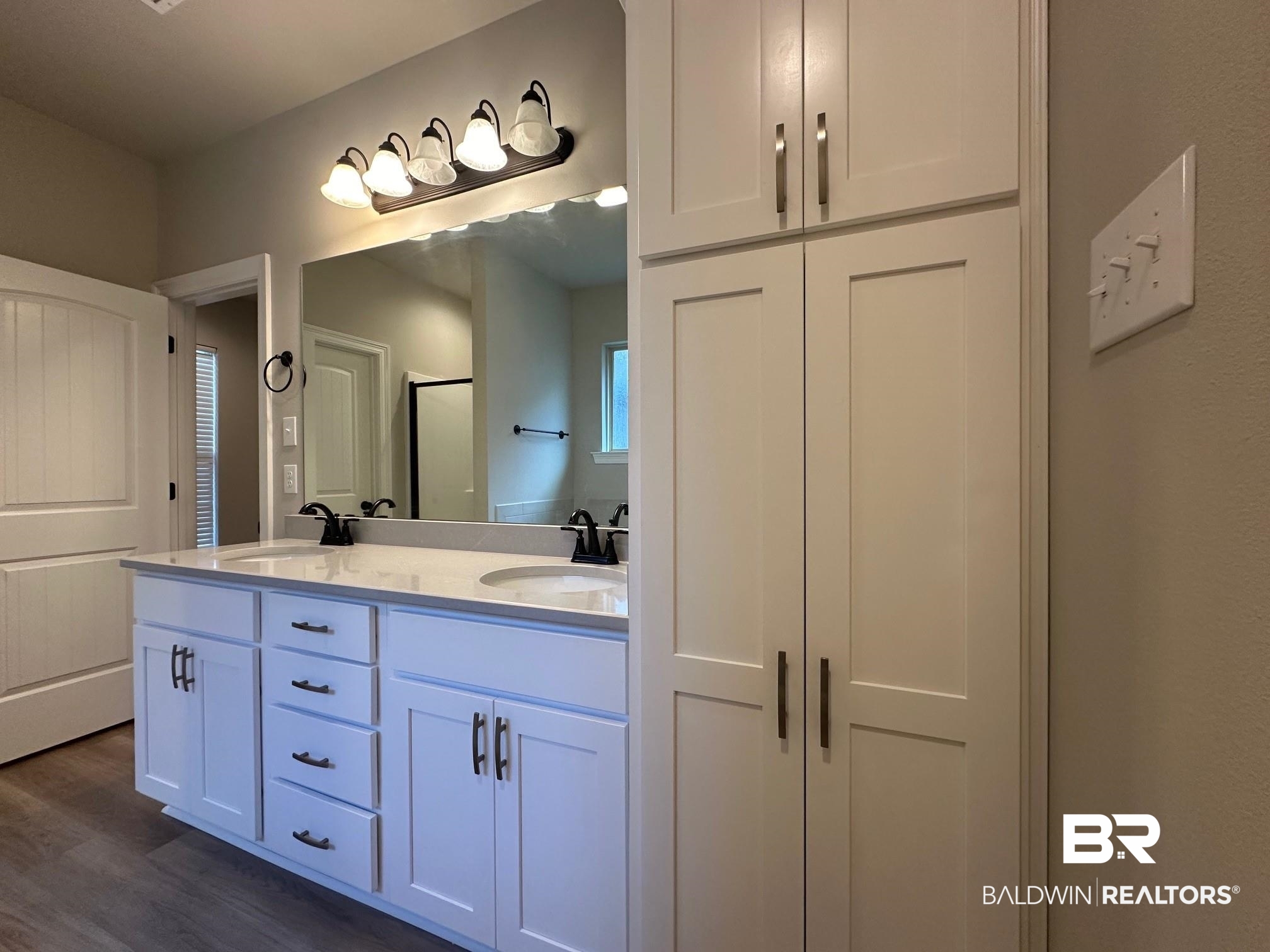 1009 Ruisseau Drive Foley, AL 36535 - Photo 44 of 55 Bathroom featuring vanity, a shower with shower door, and wood-type flooring