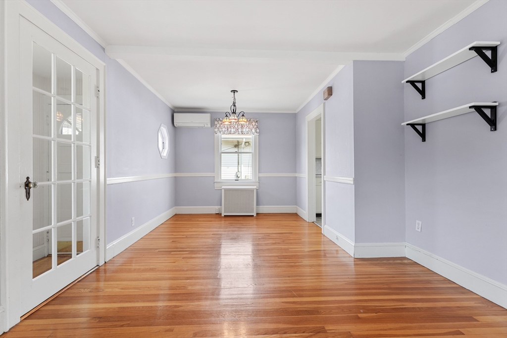 71 Woodland Road Malden, MA 02148 - Photo 11 of 41 a view of an empty room with a window and wooden floor