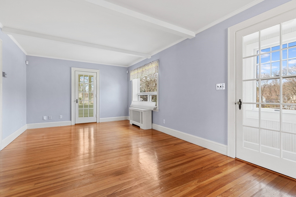 71 Woodland Road Malden, MA 02148 - Photo 12 of 41 a view of an empty room with window and wooden floor