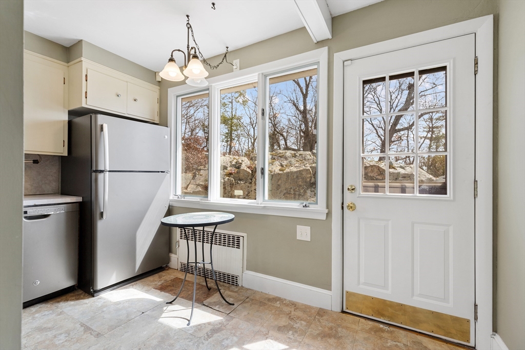 71 Woodland Road Malden, MA 02148 - Photo 15 of 41 a kitchen with stainless steel appliances granite countertop a refrigerator and a window