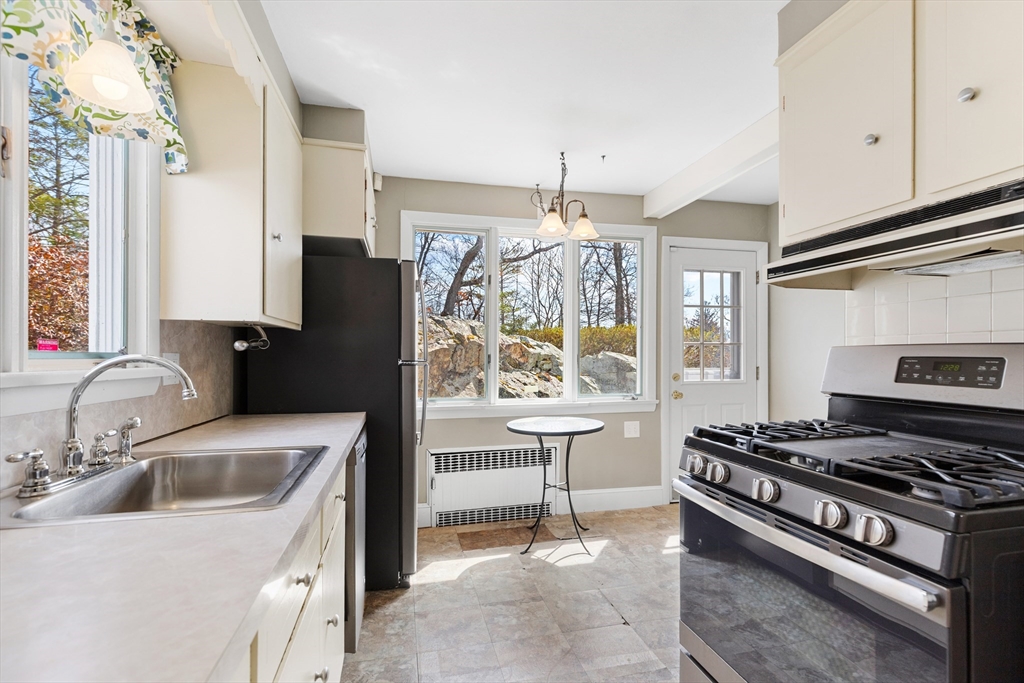 71 Woodland Road Malden, MA 02148 - Photo 16 of 41 a kitchen that has a stove a sink and a refrigerator