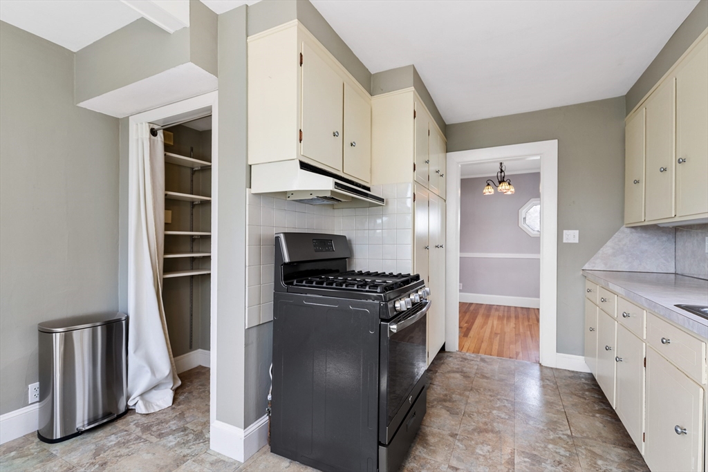 71 Woodland Road Malden, MA 02148 - Photo 17 of 41 a kitchen with stainless steel appliances granite countertop a stove and a refrigerator