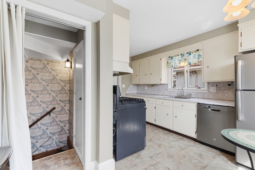 71 Woodland Road Malden, MA 02148 - Photo 18 of 41 a kitchen with granite countertop a sink stove and refrigerator