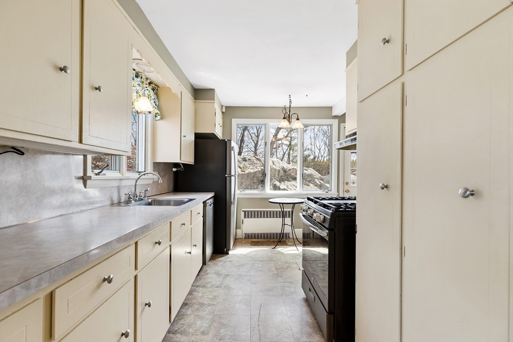 71 Woodland Road Malden, MA 02148 - Photo 19 of 41 a kitchen with a sink stove and refrigerator