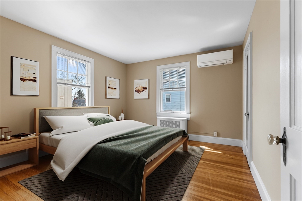 71 Woodland Road Malden, MA 02148 - Photo 20 of 41 a bedroom with a bed and wooden floor