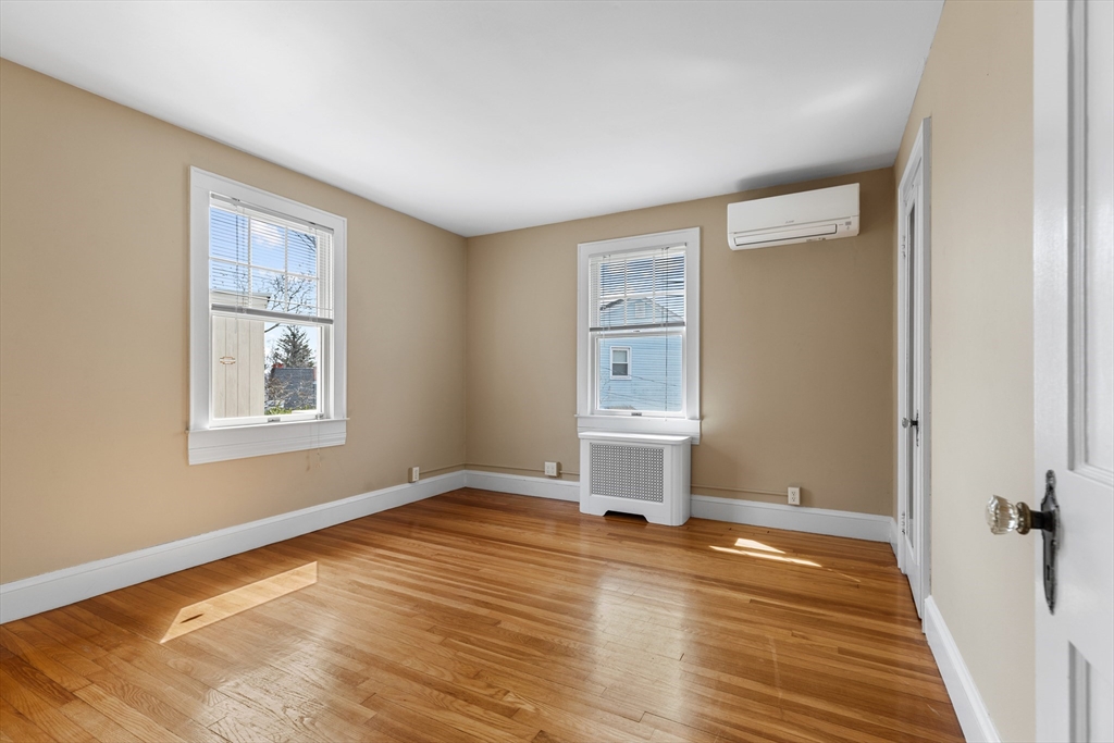 71 Woodland Road Malden, MA 02148 - Photo 21 of 41 a view of a room with wooden floor and window
