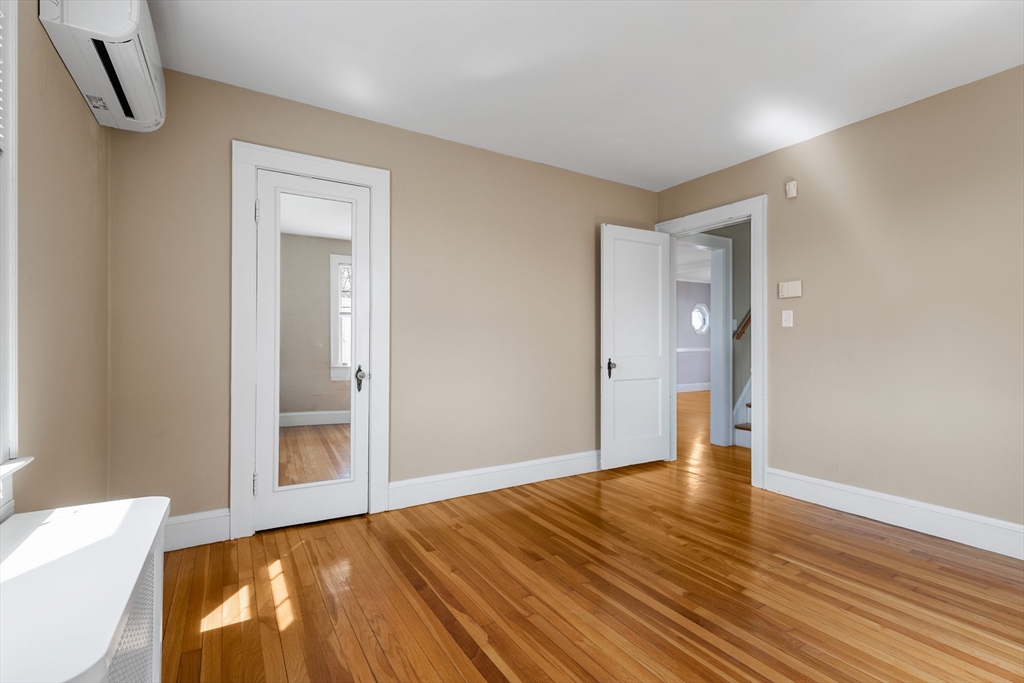 71 Woodland Road Malden, MA 02148 - Photo 22 of 41 a view of an empty room with wooden floor