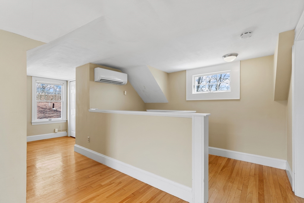 71 Woodland Road Malden, MA 02148 - Photo 27 of 41 a view of a hallway with wooden floor and a cabinet