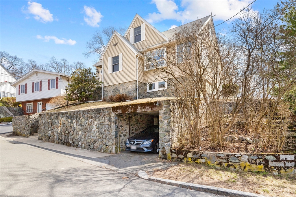 71 Woodland Road Malden, MA 02148 - Photo 3 of 41 a view of a white house with large windows and a small yard