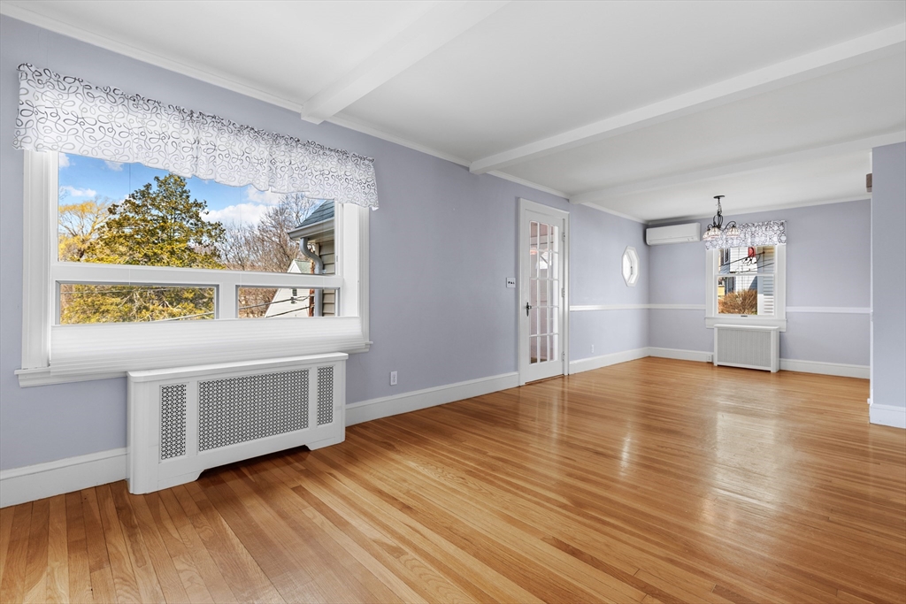 71 Woodland Road Malden, MA 02148 - Photo 6 of 41 a view of an empty room with a window and wooden floor