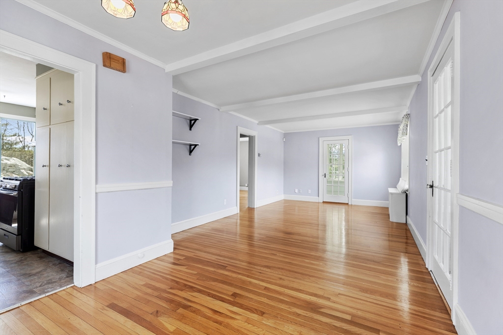 71 Woodland Road Malden, MA 02148 - Photo 9 of 41 a view of an empty room with wooden floor and a bathroom