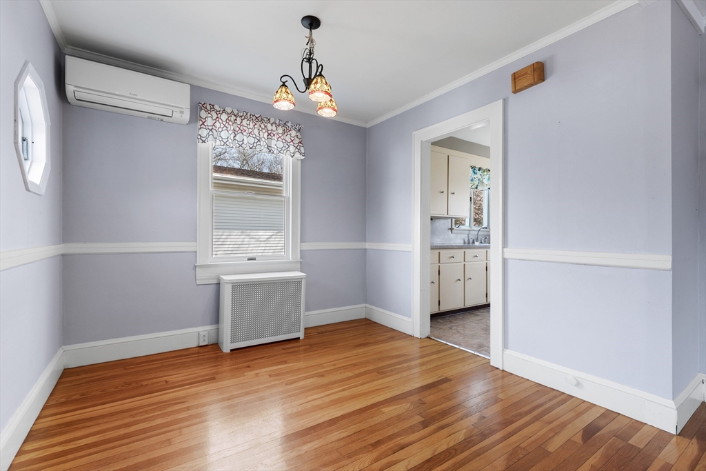 71 Woodland Road Malden, MA 02148 - Photo 10 of 41 a view of an empty room with wooden floor and a window