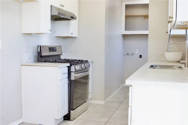 a kitchen with a refrigerator and cabinets