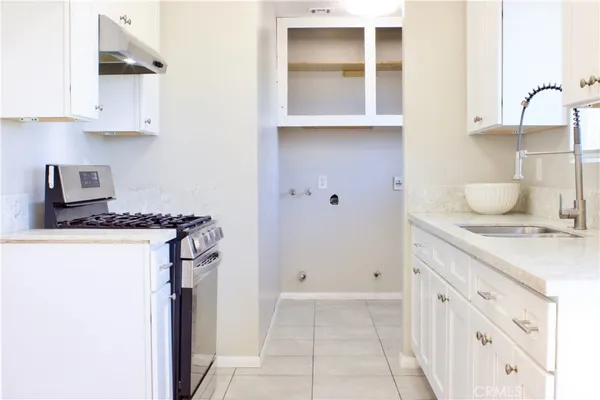 a kitchen with stainless steel appliances granite countertop a sink stove and cabinets